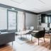 Campanile Vannes in Vannes: modern lounge with seating, bar stools and large TV near a glass door