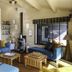Les Vignes de la Chapelle, Sainte-Marie-de-Ré lounge with blue sofas, wood tables and stove