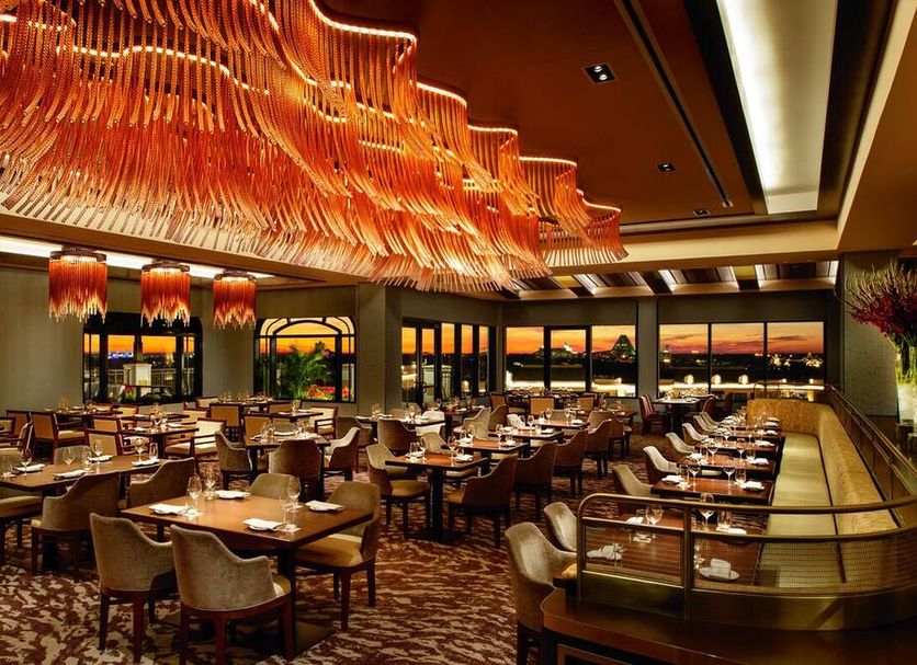 Disney's Riviera Resort in Lake Buena Vista dining room with ornate orange chandelier and sunset views