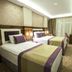 Ruba Palace Thermal Hotel in Bursa: twin beds in a guest room with window curtains and wall-mounted TV