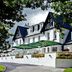 Ilsington Country House Hotel & Spa in Newton Abbot, white country house with terrace and flower boxes