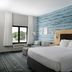TownePlace Suites by Marriott Savannah Airport guest room with king bed, sofa, and window view in Savannah