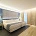 Catalonia Porto guest room in Porto with king bed, floor-to-ceiling curtains and modern seating