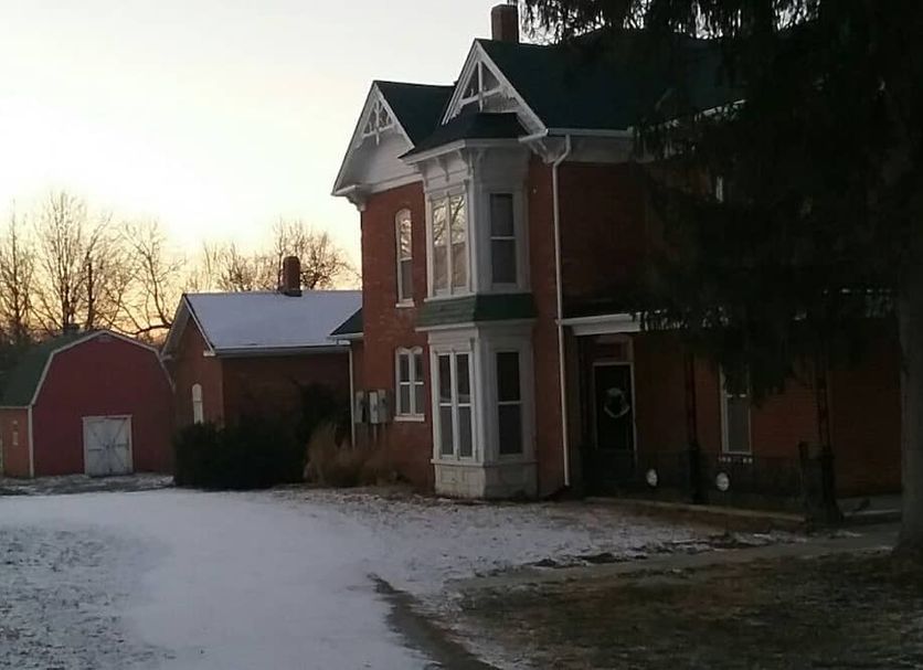Smithville Historical Museum and Inn in Smithville, brick inn with snow-covered grounds at dusk