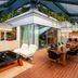 Hotel Eclat Beijing rooftop terrace with outdoor seating and glass pavilion in Beijing