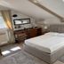 Oasis Lagoon Estate Venice attic guest room with double bed, desk and skylight