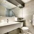 Hotel Marineau Shawinigan bathroom with sink, toilet, large mirror and wall-mounted towels