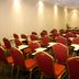Hotel Diego de Almagro Puerto Montt conference room with rows of red chairs and writing tablets