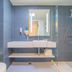 Hanting Hotel Shanghai Xujiahui Metro Station bathroom with walk-in shower and wall-mounted sink in Shanghai
