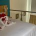 Hotel Dorado Ferial Bogotá room with heart-shaped towel swans and red pillows on the bed
