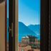 Casa Brenna Tosatto Art Experience in Lenno with lake and mountain view through a window