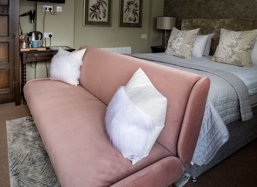 The Brewers Inn, Cambridge guest room with bed, sofa, wall art and ceiling lights