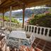Hotel Bahia Taganga terrace with tables, sea view, and boats in Taganga