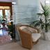 Hotel Rosa Del Tirreno in Quercianella lobby seating with wicker chairs and a potted palm