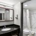 Red Roof Inn Richmond - Airport Sandston bathroom with vanity, mirror and tub-shower combo