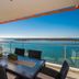 Silvershore Apartments on the Broadwater in Biggera Waters: balcony dining table with oceanfront views