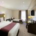 Premier Inn Thurrock East in Grays hotel room with two beds, wall-mounted TV and desk