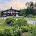 Innsbruck Inn at Stowe exterior with landscaped lawn and mountain backdrop in Stowe