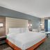Best Western Porterville Inn guest room with king bed, armchair, and window view in Porterville
