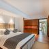 Beijing Lian Jie Hotel in Beijing guest room with king bed, wood paneling, and seating area