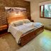 Del Glaciar Libertador Hotel in El Calafate, room with double bed, brick accent wall and window view