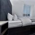 The Z Hotel Holborn, London guest room with double bed, desk, and modern minimalist decor