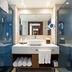 Sonesta Maho Beach Resort Casino & Spa bathroom in Lowlands with double vanity, mirror, glass showers and bathtub