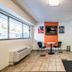 Motel 6 Birmingham lobby with check-in desk, seating area, wall TV, and large front windows