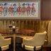 Best Western Heath Court Hotel Newmarket lounge with curved gold banquette, round table and framed horse artwork