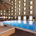 Fairfield by Marriott Bengaluru Outer Ring Road poolside lounge with umbrellas and indoor pool in Bengaluru