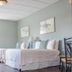 Trailhead Lodging in Seward guest room with two beds, window, and simple seating