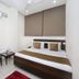 Oyo 8959 New Dk Palace Chandigarh room with double bed, air conditioner, chair and small table