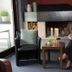 Familienhotel Mateera Gargellen lounge with fireplace and seated guest in Montafon