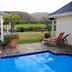 Mulligans Guest Lodge in Hermanus with a gazebo beside a pool and mountain views