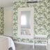 Hotel Cristal Praia Resort & Spa room with tropical wallpaper, double bed, and wall-mounted TV in Vieira de Leiria