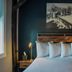 Old Mill Inn, Hatfield: cozy guest room with bed, bedside lamps, and winter landscape wall art