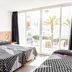 Ibiza Rocks Hotel in Sant Antoni de Portmany room with three beds and balcony doors to palm view