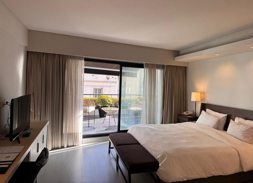 Libertad Hotel Buenos Aires guest room with king bed and balcony door in Buenos Aires