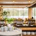 The Velo's Hotel And Bmx Pump Track buffet dining area in Aranyaprathet with plated dishes and plants