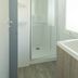 Del Garda Village and Camping bathroom with glass shower, vanity sink, and window in Peschiera del Garda