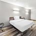 Studio 6 King of Prussia PA Philadelphia room with bed, desk, chair, and mini fridge in King of Prussia