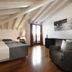Hotel del Porto in Torri Del Benaco guest room with twin beds, leather chair, and balcony doors