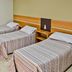 Tri Hotel Centro Chapecó room with three single beds and tiled floor in Chapecó