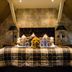 The Coed-Y-Mwstwr Hotel in Bridgend bedroom with plaid bed, lamps and stuffed dog on the bed