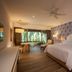 The Hacienda at Krystal Grand Puerto Vallarta guest room with patterned accent wall and garden-view seating area