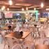 Hotel Embaixador in Porto Alegre dining area with tables, chairs, and warm hanging lights