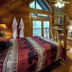 A Cabin In The Woods in Pigeon Forge: rustic cabin bedroom with jacuzzi tub and mountain-view windows