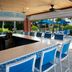 Sanibel Island Beach Resort bar with blue stools and patio seating overlooking the pool and ocean