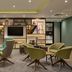 Holiday Inn London - Bloomsbury lobby lounge with modern seating and decorative shelving in London