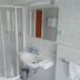 Pension Sonnalp in Ortisei bathroom with shower, sink, mirror and towel rack